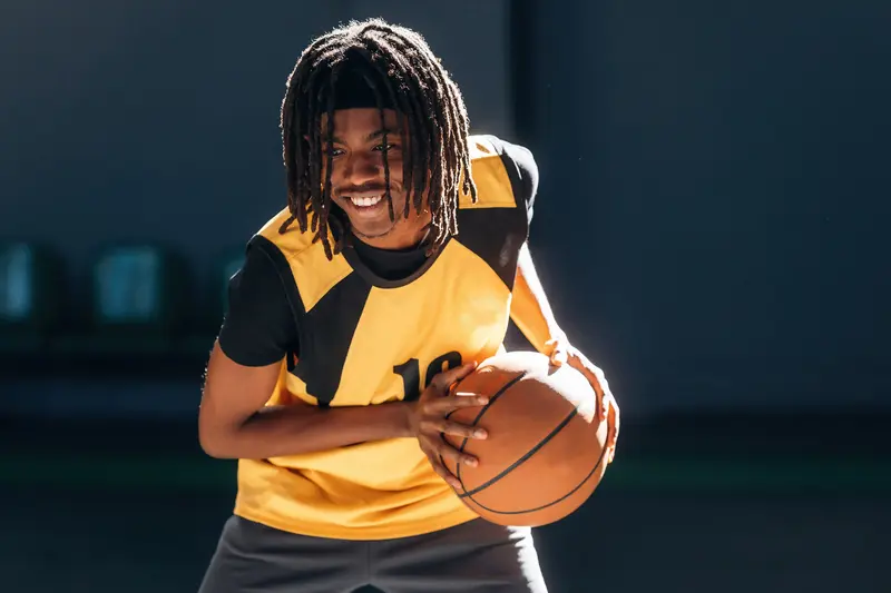 Basketball player holding the ball in a triple threat stance ready to make a move